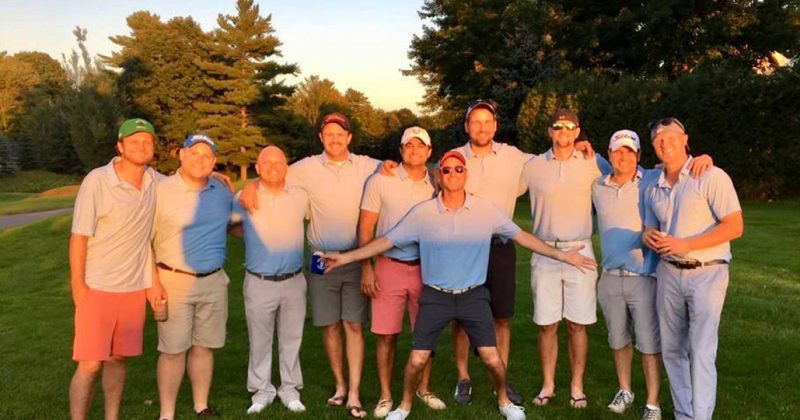 group of male golfers in sunlight
