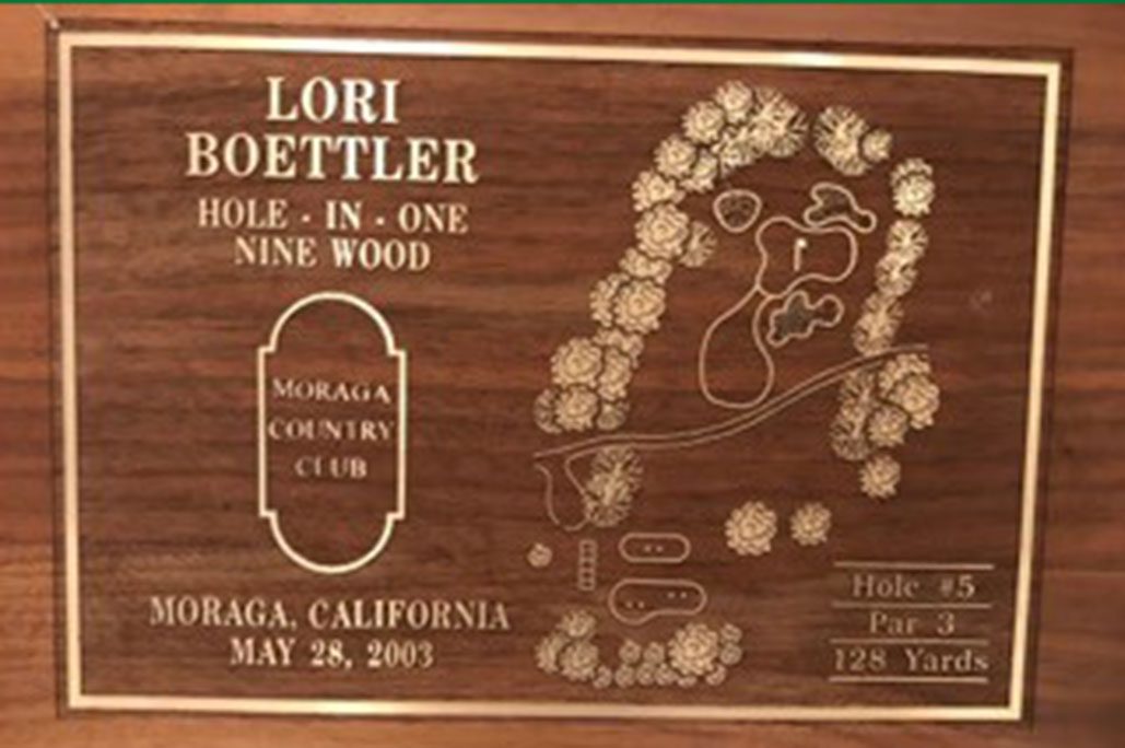 A wooden sign commemorating Lori Boettler's hole-in-one at Moranga Country Club's Hole 5 in 2003. 