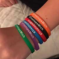 Colorful rubber bracelets on an arm