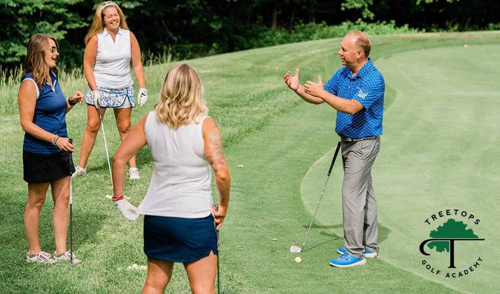 A golf instructor provides a golf lesson to three students, with the Treetops Golf Academy logo in the bottom right corner.