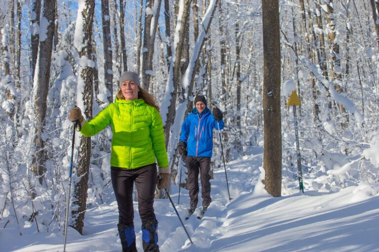 |Man and woman in ski clothes and hats on for cross country skiing michigan