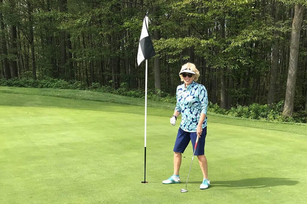 Female golfer in green|Lori Boettler Award Image